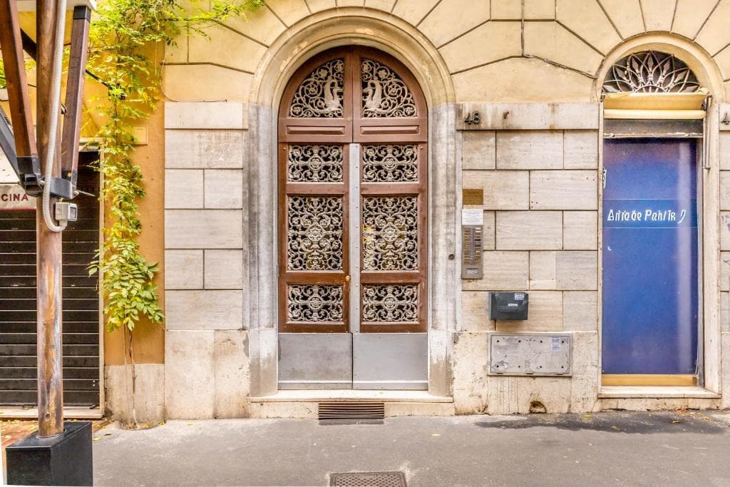 Ornate entrance portal of the building at Via della Frezza 48